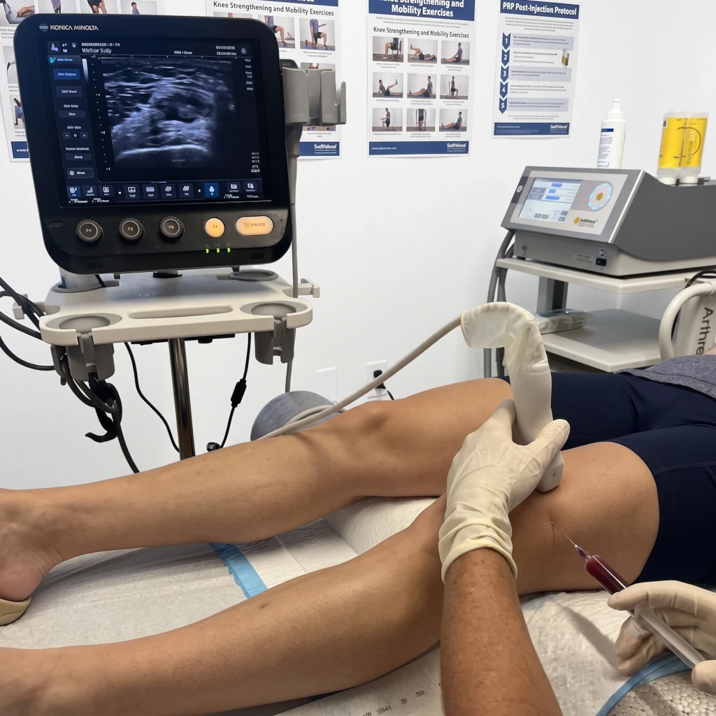 Ultrasound-guided injection being performed on a patient's knee in the clinic